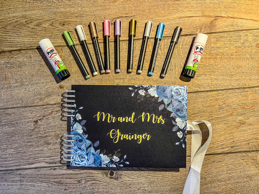 Photo Booth guest book with metallic coloured pens and blue sticks