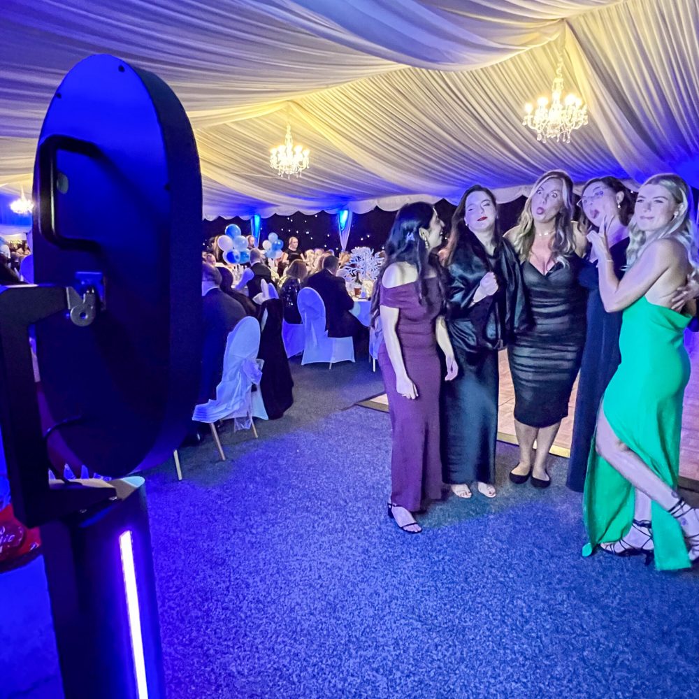 Ladies using the Maxi Glow Booth at John Eastwood Hospice Charity Ball